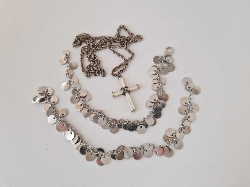 A silver cross and chain, plus two silver brooches