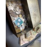 A tin of world coins and bank notes