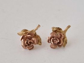 A pair of two colour earrings, 9ct