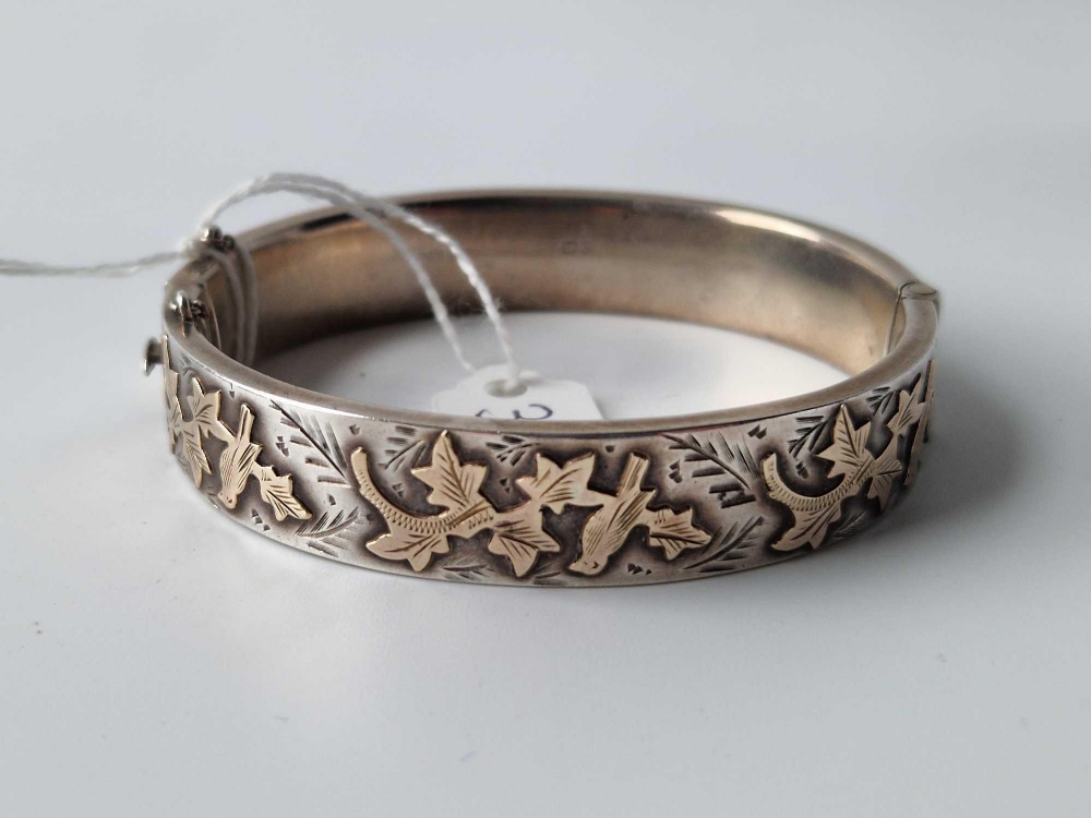 An antique silver and gold hinged bangle with full Chester hallmarks 21.4g