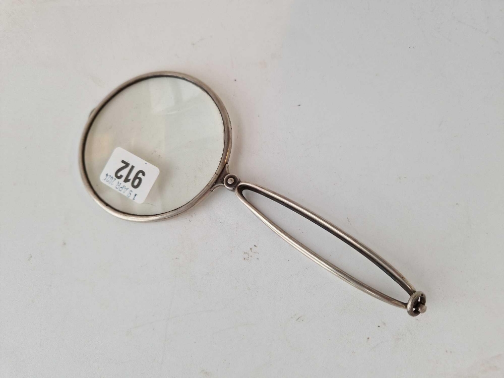 A folding silver mounted magnifying glass, 4" diameter