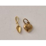 Two small gold charm in the form of a heart and a spoon