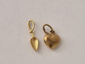 Two small gold charm in the form of a heart and a spoon