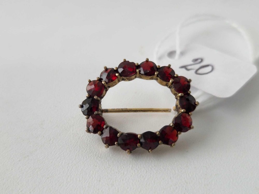 Oval garnet set brooch