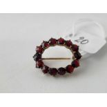 Oval garnet set brooch