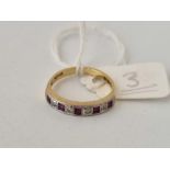 A nine stone ruby and diamond half eternity ring, 18ct, size I