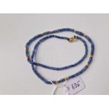 A sapphire bead necklace with gold clasp