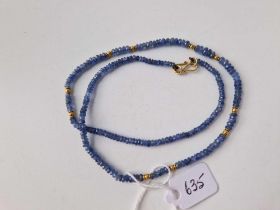 A sapphire bead necklace with gold clasp