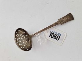 A Victorian sifter spoon decorated in the aesthetic style with birds and foliage, 5 inches long,