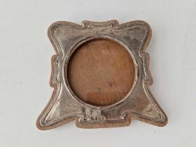 An Art Nouveau photo frame, shaped outline and circular aperture, 5 inches wide, Birmingham 1904