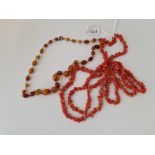 A twig coral necklace and an amber example