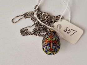 An early 20thc silver gilt & enamel egg pendant on silver chain 26”