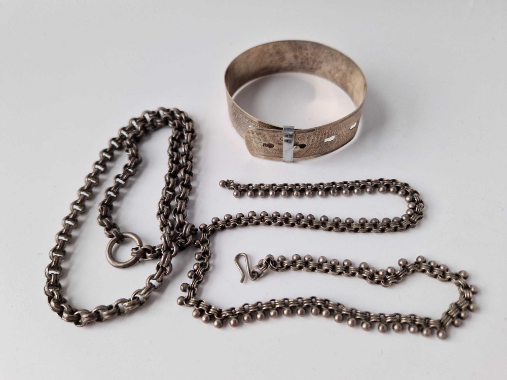 A silver bangle and two silver chains, 46 g.