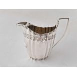 A George III cream jug with ribbed body, London 1797 by WS, 173 g.
