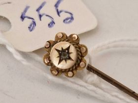 A diamond topped stick pin, 9ct