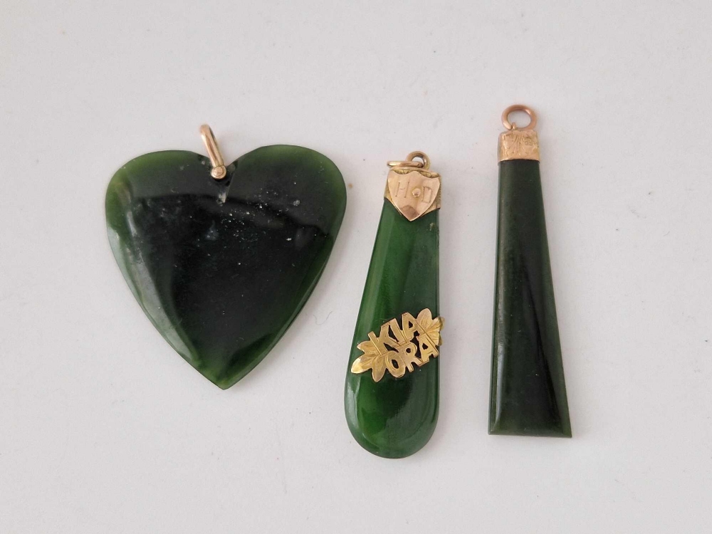 Three gold mounted jadeite pendants