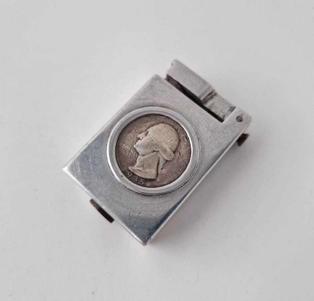 An old lighter with silver coin inset