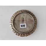 A late Victorian circular photo frame with unusual shamrock decorated border, 6 inches diameter,