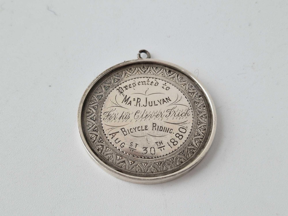 A silver large medal for bicycle riding for 1880 and inscribed for his clever trick, 2 inches