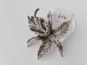 A silver and marcasite lilly brooch