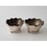 A pair of stylish salts with wavy rims bracket feet, 2.25 inches wide, London 1883 by JWH & JTH,