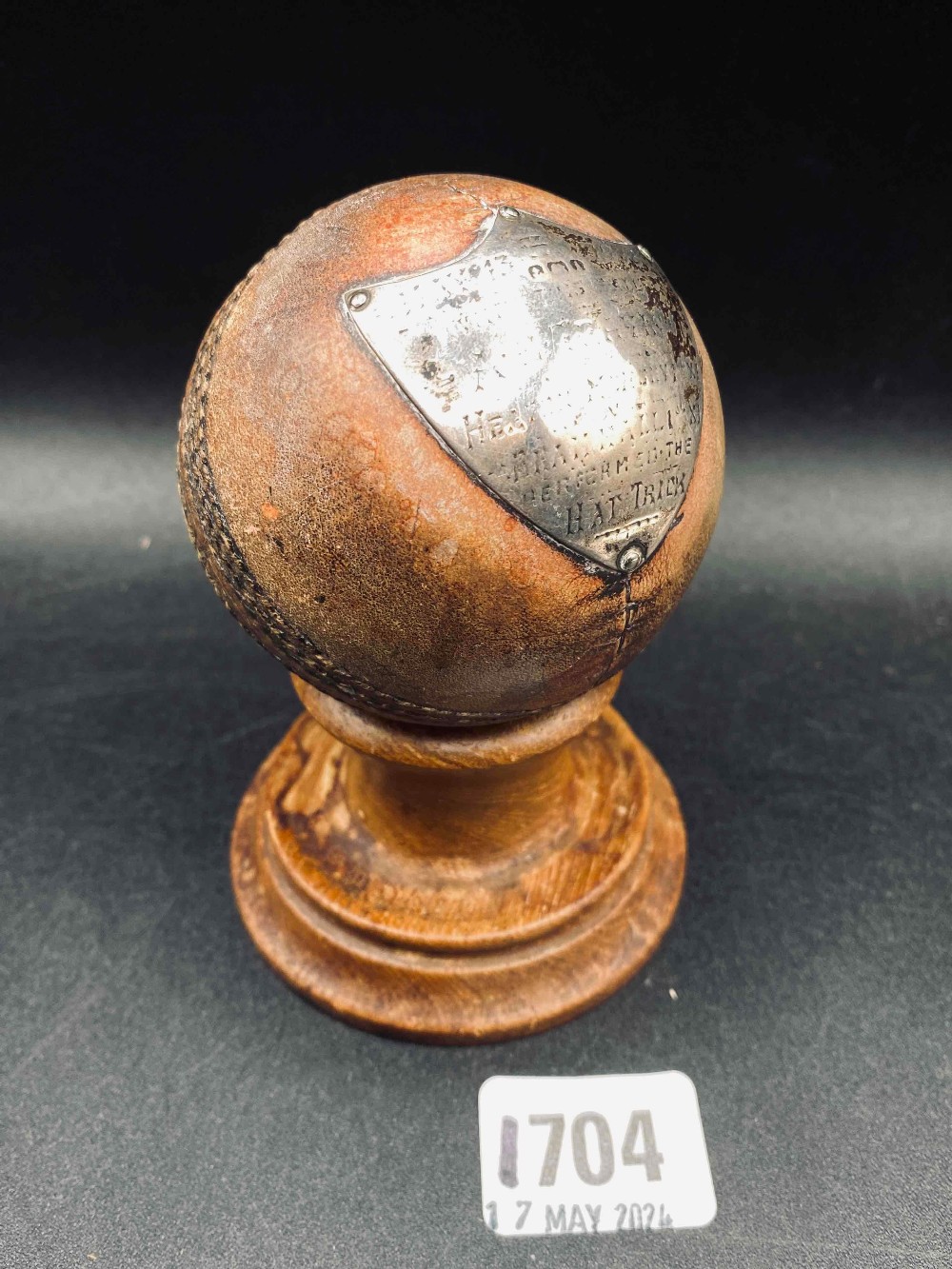 Silver mounted cricket ball with plaque on turned wood stand