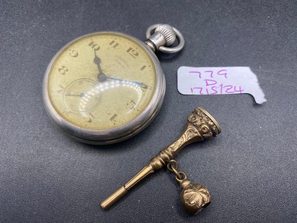 A silver INGERSOLL pocket watch with gilt key and seconds dial