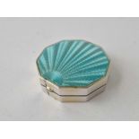 An octagonal compact with green enamel cover, 2 inches wide,