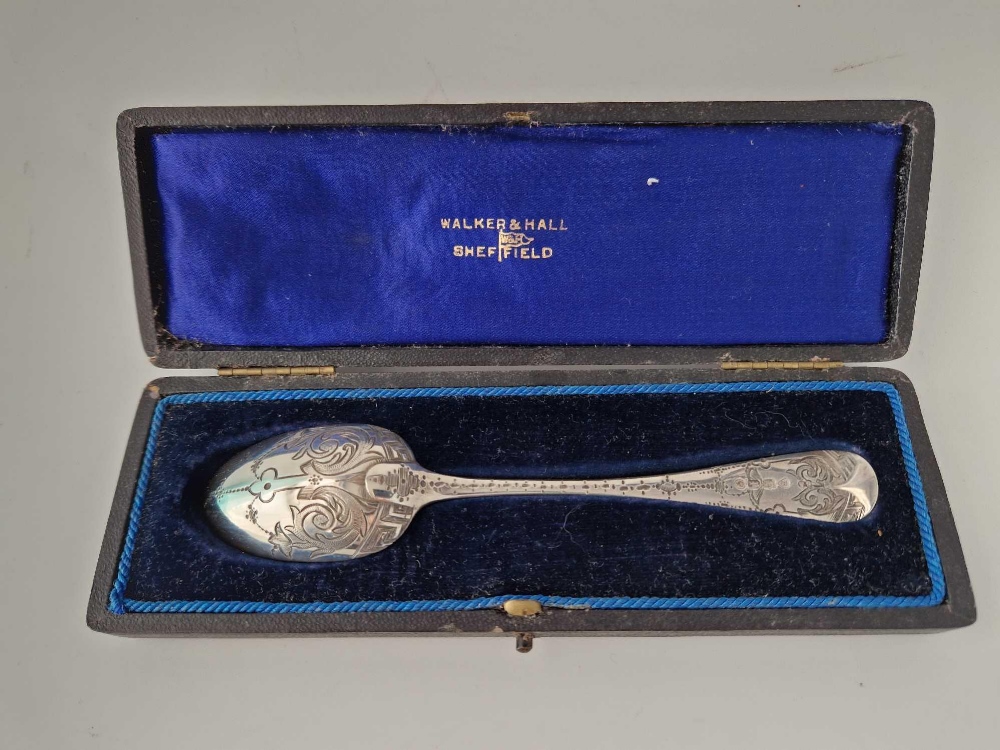 A boxed Victorian spoon engraved with scrolls, London 1970 by GA