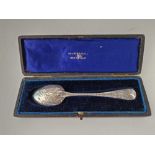 A boxed Victorian spoon engraved with scrolls, London 1970 by GA