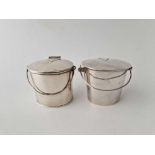 A pair of novelty milk buckets with hinged covers and handles, 2 1/4" high, one marked, Birmingham