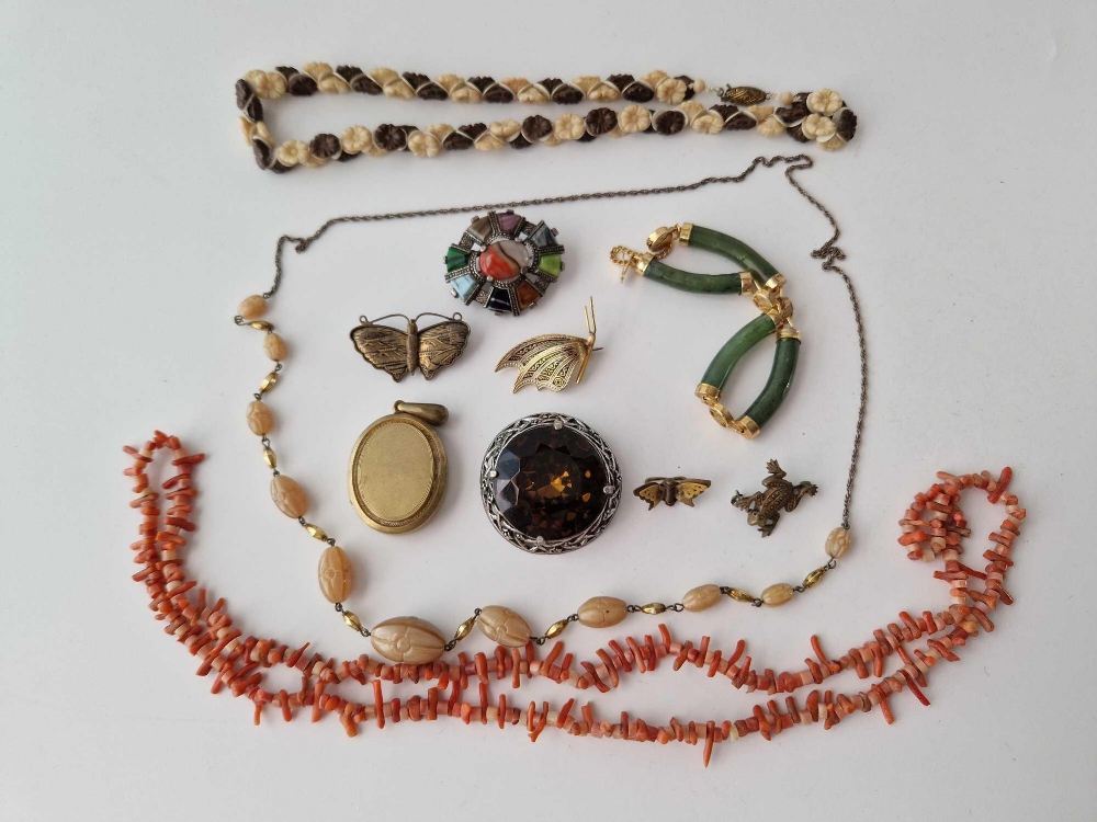 A bag of costume jewellery including a gilt locket etc.