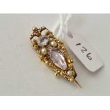 A antique Canetille gold brooch 15ct gold set with a topaz rock crystal and half pearls