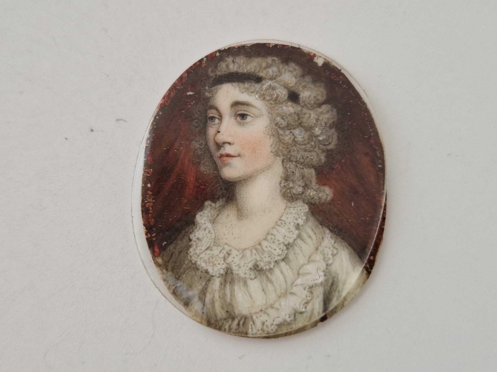 A Victorian miniature of a lady with glass cover