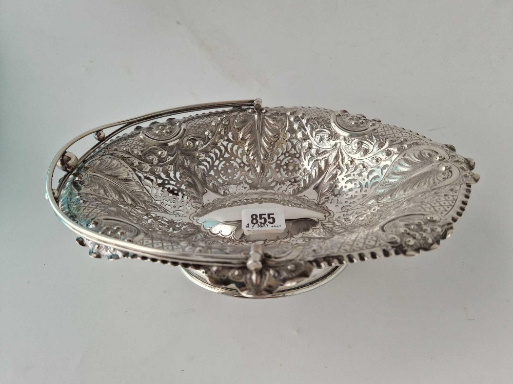 A late Victorian cake basket of Georgian design with pierced sides, swing handle, 11.5" wide, London