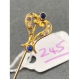 A sapphire and gem stone oriental style gold stick pin