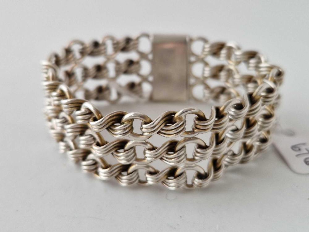 A Victorian silver wide bracelet with three row stylized knot link design substantial quality