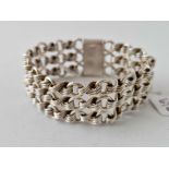 A Victorian silver wide bracelet with three row stylized knot link design substantial quality