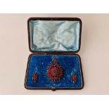 A ANTIQUE GARNET BROOCH AND EARRING SET BOXED