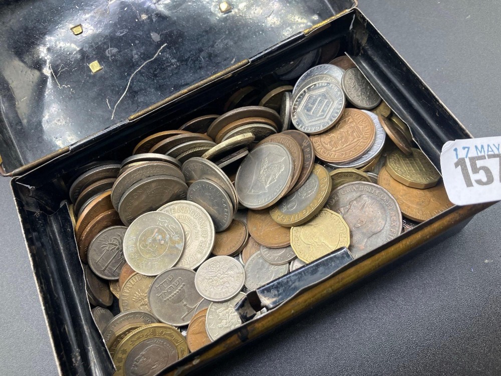 Tin of foreign coins