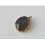 A antique engraved gold back locket