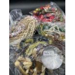 Four large bags of assorted costume jewellery