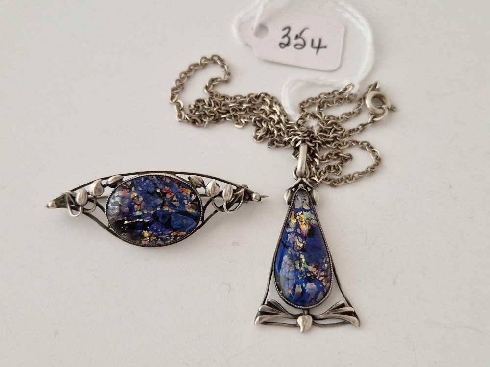 A art nouveau silver and harlequin foiled glass pendant and brooch by Thomas L Mott