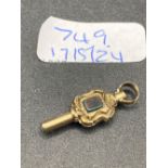 A antique stone set watch key gold cased