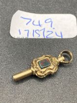 A antique stone set watch key gold cased