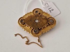 A Victorian five stone memorial brooch set in gold with locket back 7 gms