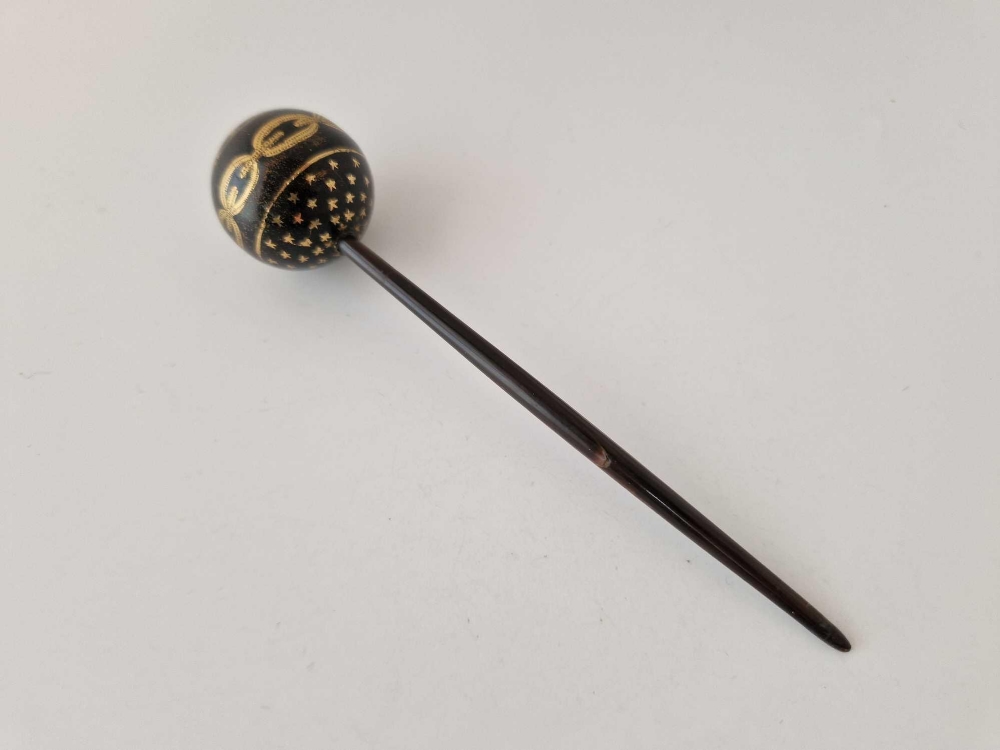 A large Victorian tortoiseshell pique hair pin