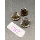 A pair of matched octagonal smokey quartz gem stones with a larger single gem stone to match 28