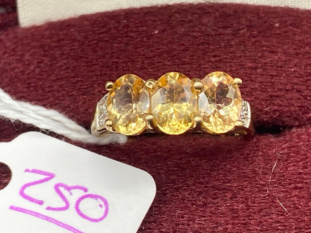 A three stone yellow sapphire diamond ring 9ct size O 3.2 gms