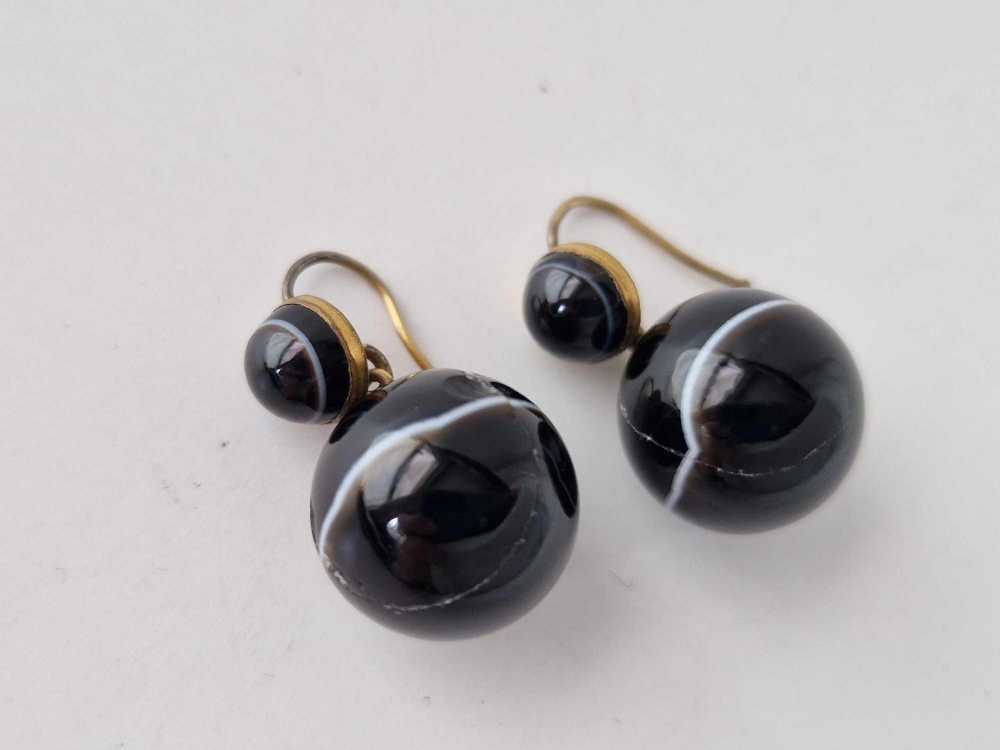 A pair of banded agate ball earrings - One stone cracked and glued
